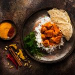 Chicken tikka masala spicy. Indian meat dish in metal plate, rice and naan bread